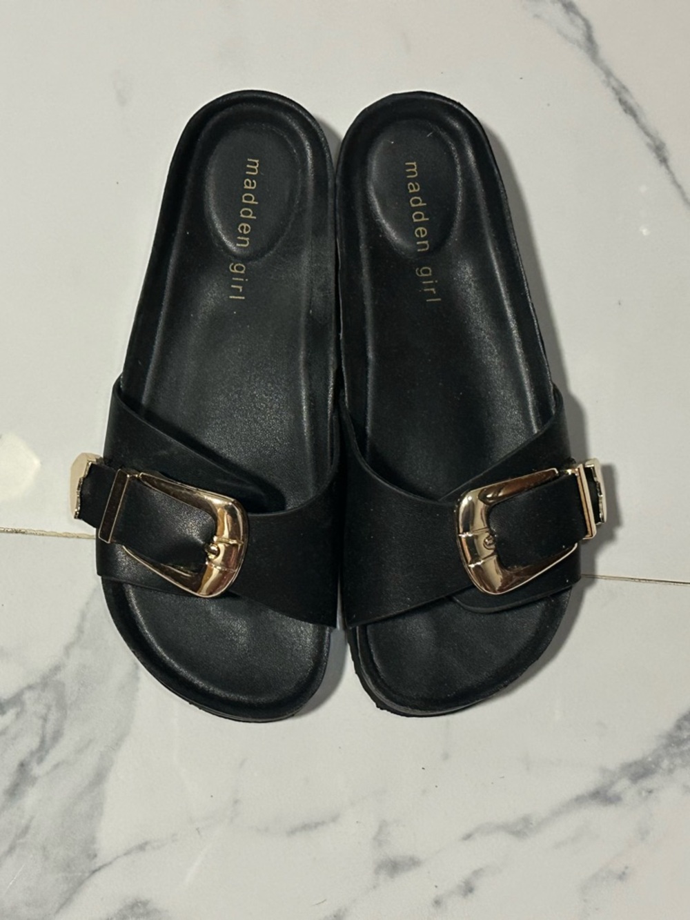 Madden Girl black leather slides with gold heart accents on buckle